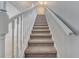 Carpeted staircase with white banister and railing leading upstairs at 943 Van Loon Ct, Kissimmee, FL 34758