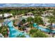 Aerial view of community pool with lazy river, tiki hut, and lush tropical landscaping at 1048 Leader St, Davenport, FL 33896