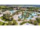 Overhead shot of large community pool area with lazy river, cabanas, and beach volleyball at 1048 Leader St, Davenport, FL 33896