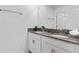 Contemporary bathroom with double sinks, gray countertop, and modern decor at 1048 Leader St, Davenport, FL 33896