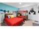 Colorful ' bedroom with a full bed, bunk beds and cartoon character wall decor at 1048 Leader St, Davenport, FL 33896