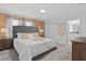 Cozy bedroom featuring a tufted headboard, soft bedding, and access to an en-suite bathroom at 1048 Leader St, Davenport, FL 33896