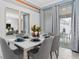 Elegant dining room with a marble table, seating for six, and stylish decor with outside view at 1048 Leader St, Davenport, FL 33896