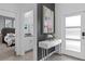 Stylish entryway with white console table, modern art, and view into bedroom and bathroom at 1048 Leader St, Davenport, FL 33896