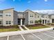 Modern townhomes with gray stone accents, landscaped front yards, and ample parking at 1048 Leader St, Davenport, FL 33896