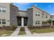 Modern townhome exterior with stone accents, manicured landscaping, and inviting entryways at 1048 Leader St, Davenport, FL 33896
