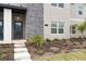 Close up of a modern townhome entrance with stone accents and landscaping at 1048 Leader St, Davenport, FL 33896