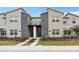 Well-maintained townhome with stone accents, contemporary design, and landscaped front yard at 1048 Leader St, Davenport, FL 33896