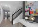 Welcoming hallway with staircase and tiled floors, showcasing a clean and modern design aesthetic at 1048 Leader St, Davenport, FL 33896