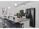 Modern kitchen featuring a spacious island with bar seating and sleek appliances at 1048 Leader St, Davenport, FL 33896