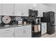 Well-equipped kitchen featuring white cabinets, gray backsplash, and modern appliances at 1048 Leader St, Davenport, FL 33896