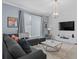 Comfortable living room featuring a sectional sofa, stylish decor, and a large flat-screen TV at 1048 Leader St, Davenport, FL 33896