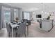Open-concept living and dining area with tile floors, modern decor, and abundant natural light at 1048 Leader St, Davenport, FL 33896