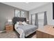Comfortable bedroom features a tufted headboard, soft neutral tones, and natural light at 1048 Leader St, Davenport, FL 33896
