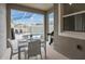 Outdoor patio with dining table and seating overlooking a pool with screened enclosure at 1048 Leader St, Davenport, FL 33896