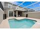 Enjoy a private screened-in pool area with an outdoor kitchen, perfect for relaxation and entertaining at 1048 Leader St, Davenport, FL 33896