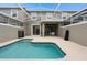A screened-in pool area boasts private relaxation and seamless indoor/outdoor living at 1048 Leader St, Davenport, FL 33896