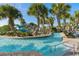 Resort-style pool with lazy river, tropical landscaping, and waterslide for Gathering fun at 1048 Leader St, Davenport, FL 33896