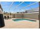 Private screened-in pool is surrounded by ample patio space with lounge chairs for relaxing at 1048 Leader St, Davenport, FL 33896