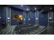 Home theater with tiered seating, projector screen, and ambient lighting for entertainment at 1048 Leader St, Davenport, FL 33896