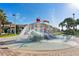 Community splash pad and water park feature with slide, dumping bucket, and palm trees at 1048 Leader St, Davenport, FL 33896