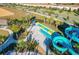 Water slides and park featuring various slides, palm trees, and lush landscaping at 1048 Leader St, Davenport, FL 33896