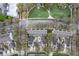 An aerial view of townhouse community reveals well-maintained landscaping, shared green spaces, and neat row housing layouts at 1154 Celebration Ave, Celebration, FL 34747