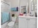 Bright bathroom features a shower with glass door, a toilet, and a white vanity with a sink and mirror at 1154 Celebration Ave, Celebration, FL 34747