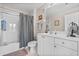 Neutral bathroom featuring a glass-enclosed tub and shower, and a long white vanity at 1154 Celebration Ave, Celebration, FL 34747