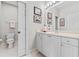 Bright bathroom featuring white cabinets, framed artwork, and a toilet closet at 1154 Celebration Ave, Celebration, FL 34747