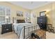 Inviting bedroom featuring black furniture, plantation shutters, and calming decor at 1154 Celebration Ave, Celebration, FL 34747