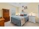 Sunny bedroom with warm paint, white furniture, shuttered window, and vibrant accents at 1154 Celebration Ave, Celebration, FL 34747