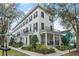 Elegant three-story townhome featuring black shutters and a charming front porch at 1154 Celebration Ave, Celebration, FL 34747