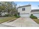 Well-maintained home exterior featuring a two-car garage, manicured shrubs, and a concrete driveway at 1154 Celebration Ave, Celebration, FL 34747