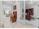 Hallway view leading to a home office with a built-in wooden desk and a patterned rug at 1154 Celebration Ave, Celebration, FL 34747