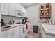 Functional kitchen featuring white cabinets, a microwave, a stovetop, and a spice rack at 1154 Celebration Ave, Celebration, FL 34747