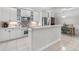 Bright kitchen featuring white cabinets, stainless steel appliances, and a breakfast bar at 1154 Celebration Ave, Celebration, FL 34747