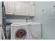 Functional laundry room with modern washer and dryer and ample storage cabinets at 1154 Celebration Ave, Celebration, FL 34747