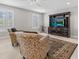 Comfortable living room with floral armchairs, a ceiling fan, and a wooden entertainment center at 1154 Celebration Ave, Celebration, FL 34747