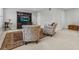 Bright living room with armchairs, a ceiling fan, and a wooden entertainment center at 1154 Celebration Ave, Celebration, FL 34747