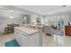 Open-concept living space with breakfast bar, tile flooring, and plenty of natural light at 1154 Celebration Ave, Celebration, FL 34747