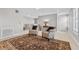 Cozy living room area featuring armchairs, a ceiling fan, and a patterned brown rug at 1154 Celebration Ave, Celebration, FL 34747