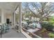 This screened-in porch offers a serene retreat, with wicker seating and views of the lush, landscaped backyard at 1154 Celebration Ave, Celebration, FL 34747