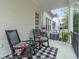 Relaxing front porch featuring rocking chairs, decorative pillows, and a black and white rug at 1154 Celebration Ave, Celebration, FL 34747