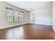 Bright bedroom featuring wood floors, ceiling fan, and large window offering lots of natural light at 133 Indian Wells Ave, Kissimmee, FL 34759