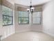 Bright dining nook with large windows and a charming chandelier fixture at 133 Indian Wells Ave, Kissimmee, FL 34759