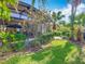 Covered lanai and a meticulously maintained lawn with tropical plants at 133 Indian Wells Ave, Kissimmee, FL 34759