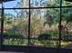 Enjoy private views of the backyard and mature trees from the screened lanai at 133 Indian Wells Ave, Kissimmee, FL 34759