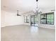 Bright and spacious living room with tile floors and large windows overlooking the backyard at 133 Indian Wells Ave, Kissimmee, FL 34759
