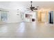 Open-concept layout connecting the living room to the kitchen, featuring tile flooring and natural light at 133 Indian Wells Ave, Kissimmee, FL 34759